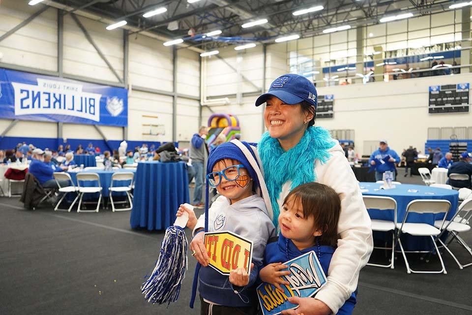 A family takes a photo at a photobooth during Alumni Fan Fest.